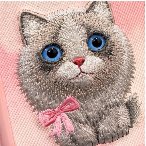 Close-up of grey kitten embroidery and blue eyes