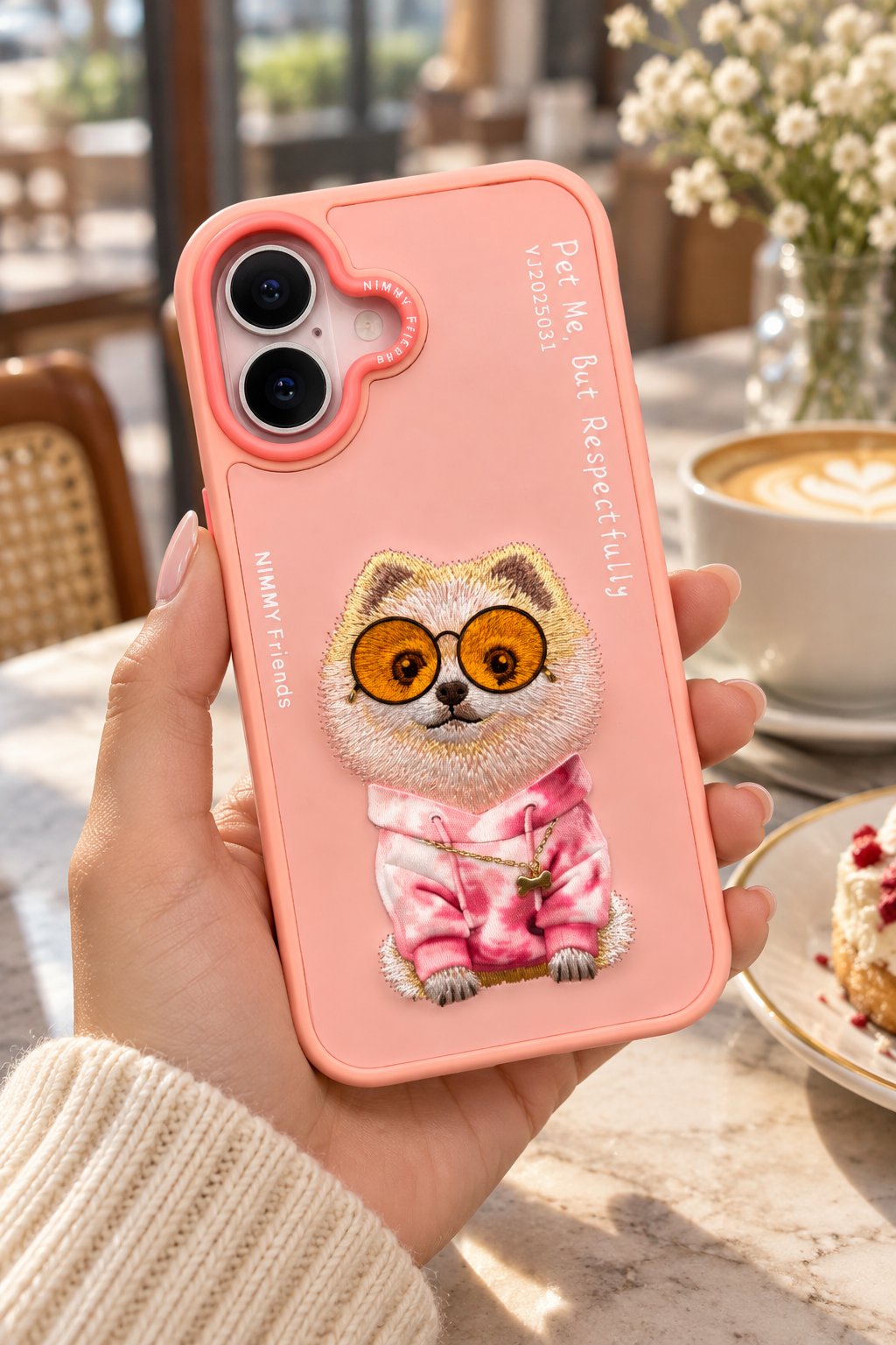 Lifestyle image of Nimmy Friends pink embroidered character phone case